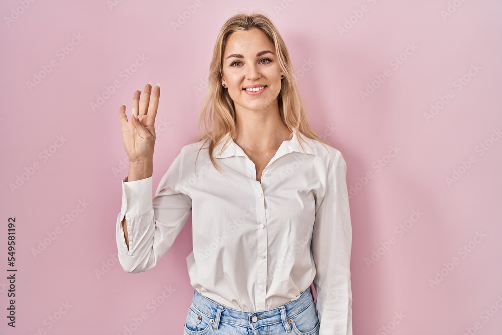 Young caucasian woman wearing casual white shirt over pink background showing and pointing up with fingers number four while smiling confident and happy. Young caucasian woman wearing casual white shirt over pink background showing and pointing up with fingers number four while smiling confident and happy.