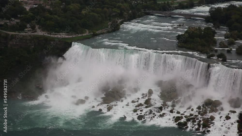 Panoramic aerial view of Canadian side view of Niagara Falls, American Falls and Observation Tower in a sunny day in Niagara Falls, Ontario, Canada Panoramic aerial view of Canadian side view of Niagara Falls, American Falls and Observation Tower in a sunny day in Niagara Falls, Ontario, Canada