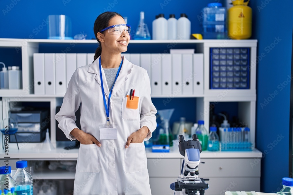 Young african american woman scientist smiling confident standing at laboratory