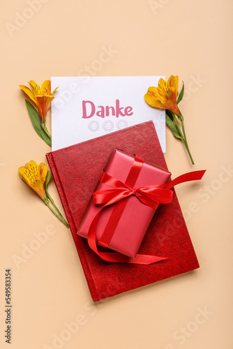 Composition with card, notebook, gift box and flowers on color background © Pixel-Shot
