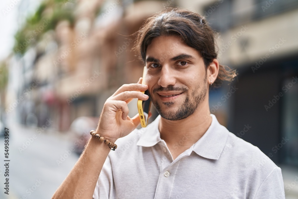 Young hispanic man smiling confident talking on the smartphone at street Young hispanic man smiling confident talking on the smartphone at street