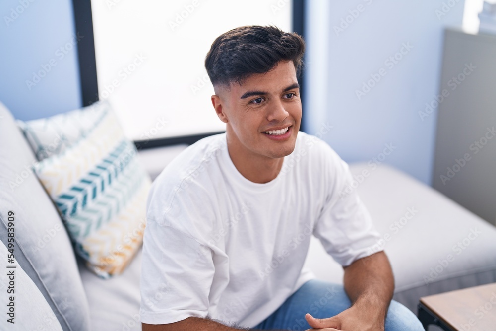 Young hispanic man smiling confident sitting on sofa at home Young hispanic man smiling confident sitting on sofa at home