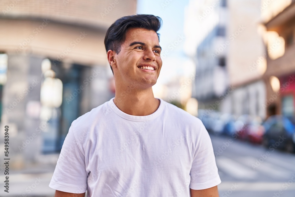 Fototapeta premium Young hispanic man smiling confident looking to the side at street