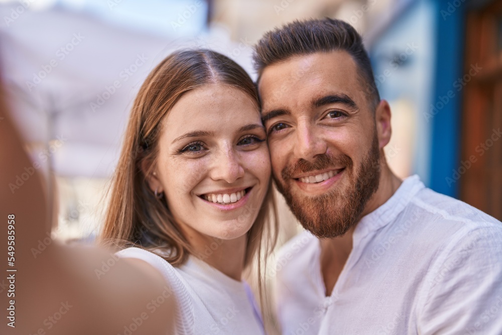 Man and woman couple smiling confident make selfie by camera at street Man and woman couple smiling confident make selfie by camera at street