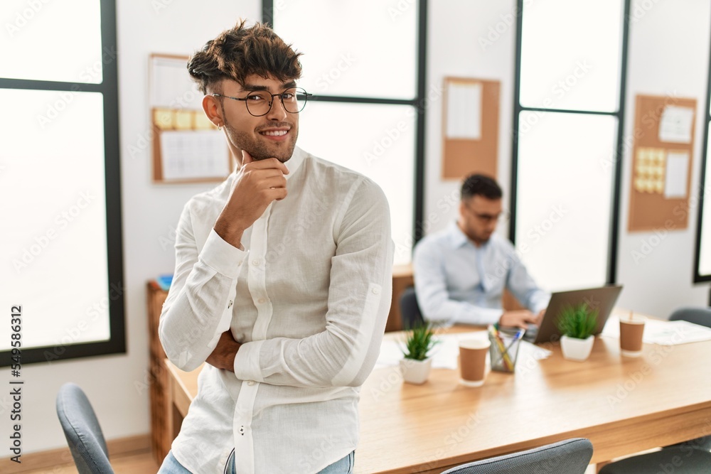 Two hispanic men business workers standing with arms crossed gesture at office Two hispanic men business workers standing with arms crossed gesture at office