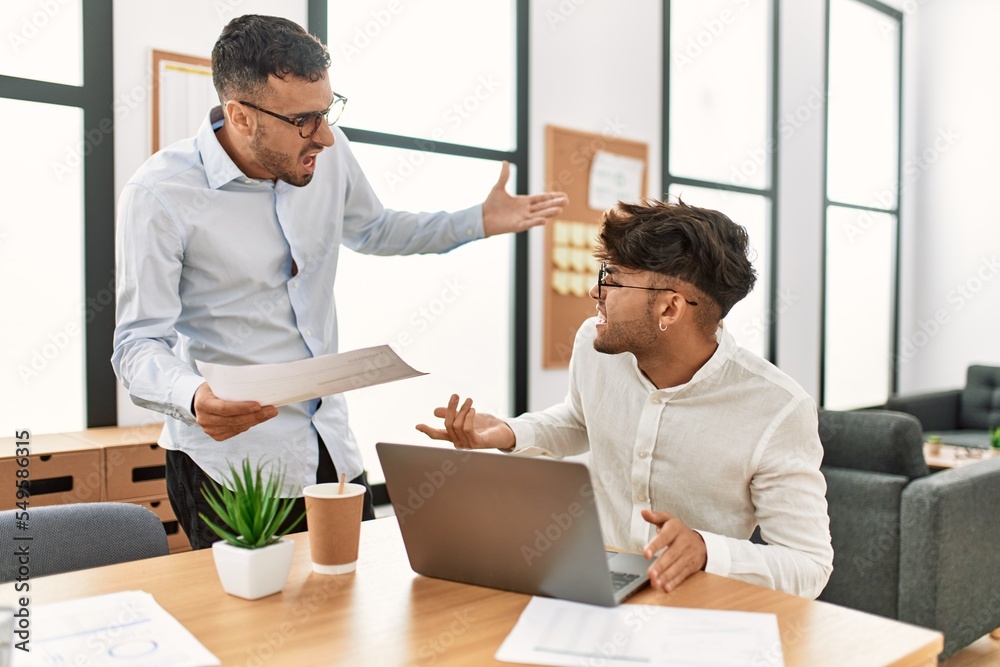 Two hispanic men business workers arguing at office Two hispanic men business workers arguing at office