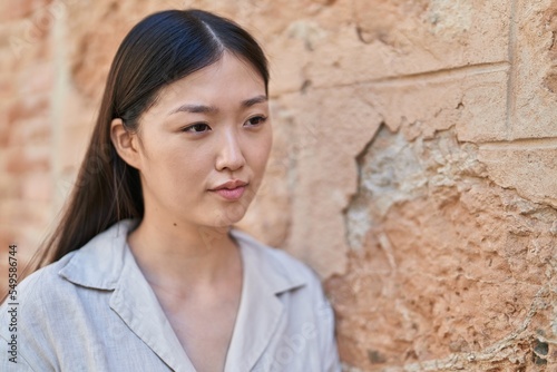 Chinese woman looking to the side with relaxed expression at street