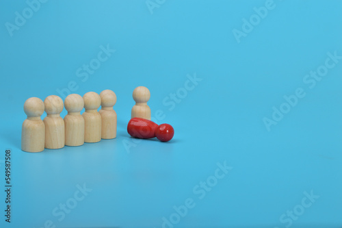 Dismissal, layoff, unemployment, employment stress. Red wooden figures overturns row group of workers.
