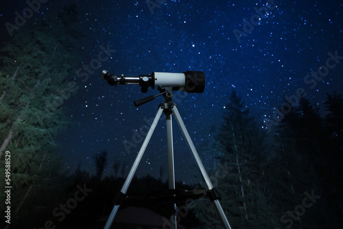 Modern telescope at night outdoors. Learning astronomy