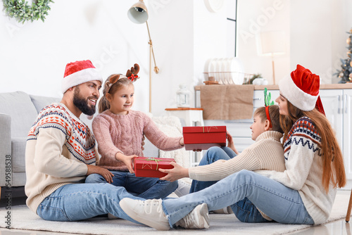 Happy family exchanging chr...
