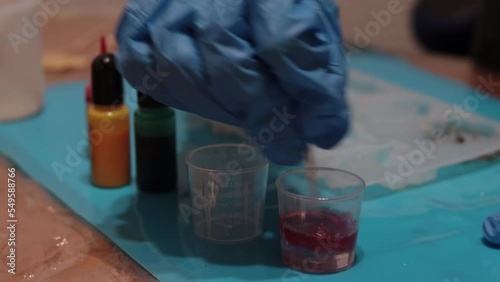 woman mixing epoxy resin pigments