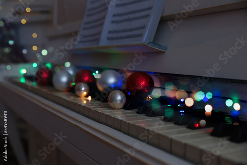 Festive decor on piano keys indoors  closeup. Christmas music