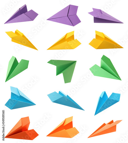 Set with handmade different color paper planes on white background