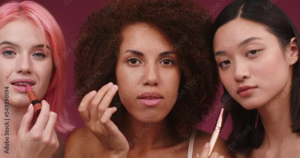 International models do makeup looking in camera and smiling International models do makeup looking in camera and smiling