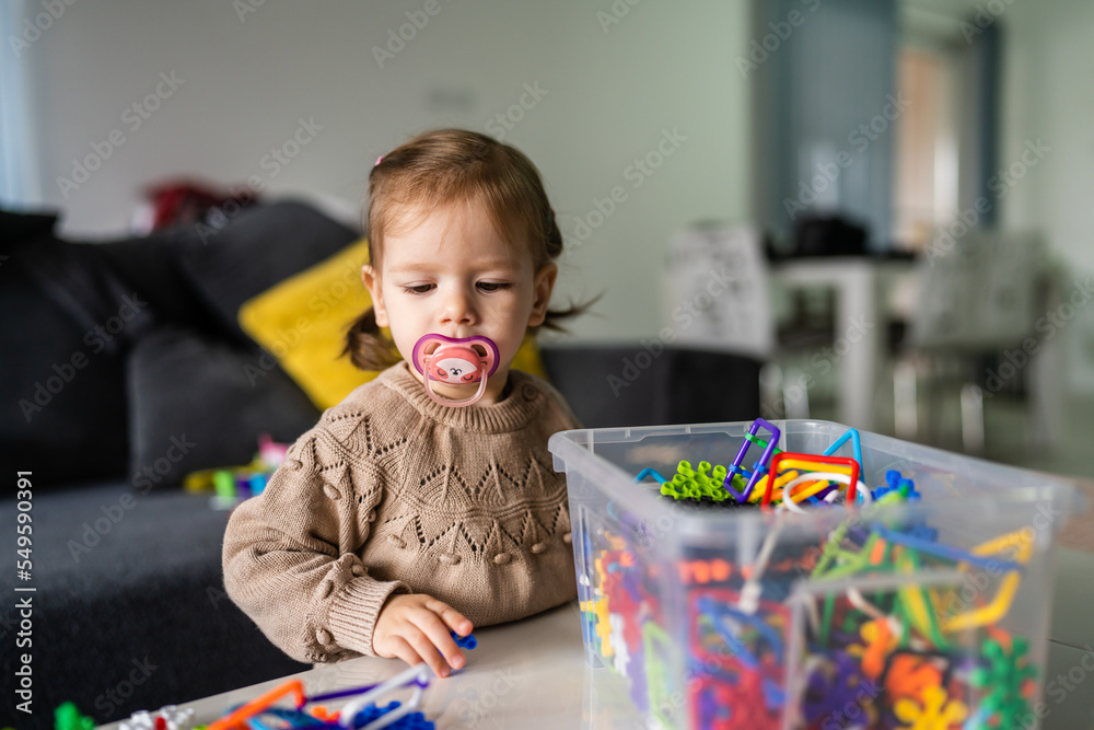 One child small caucasian girl toddler play at home alone - obrazy, fototapety, plakaty 