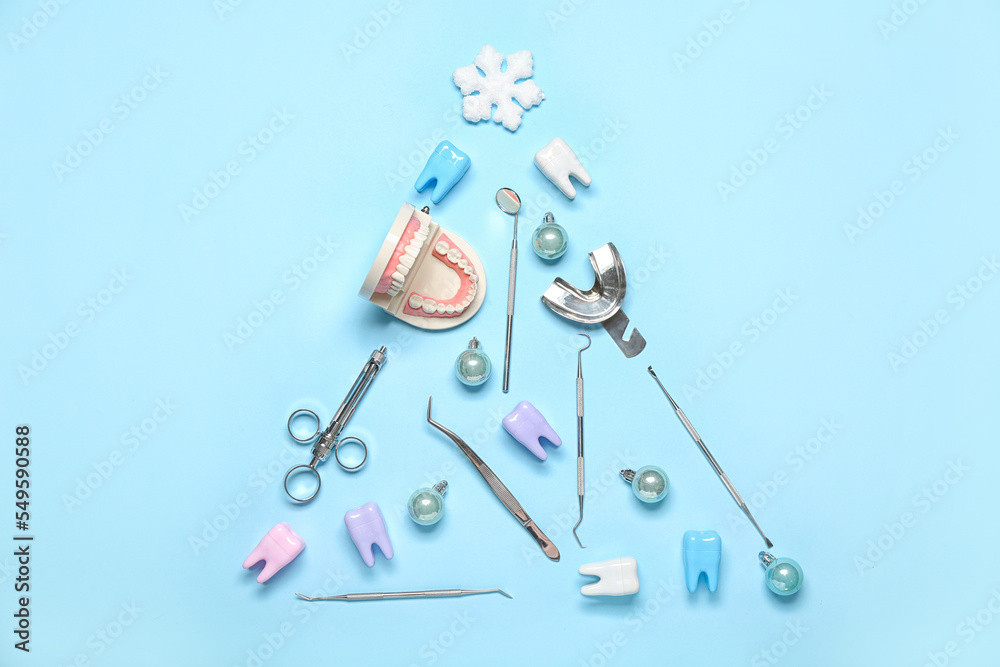 Christmas tree made of dentist's tools on blue background Christmas tree made of dentist's tools on blue background