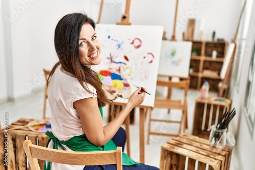 Middle age hispanic woman smiling confident drawing at art studio