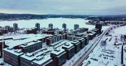 Aerial view overlooking apartments and condos in Lutakko, Jyvaskyla, winter evening in Finland - tracking, drone shot photo