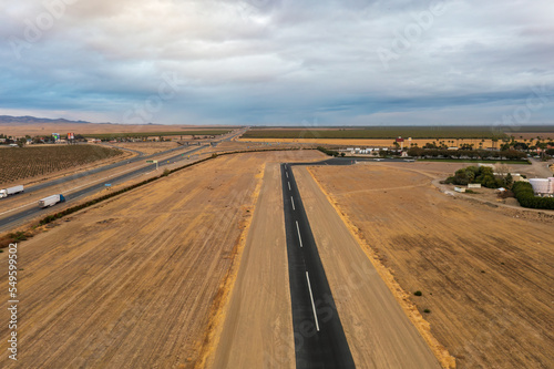 Landing strip next to Highway 5, Harris Ranch in distance. 