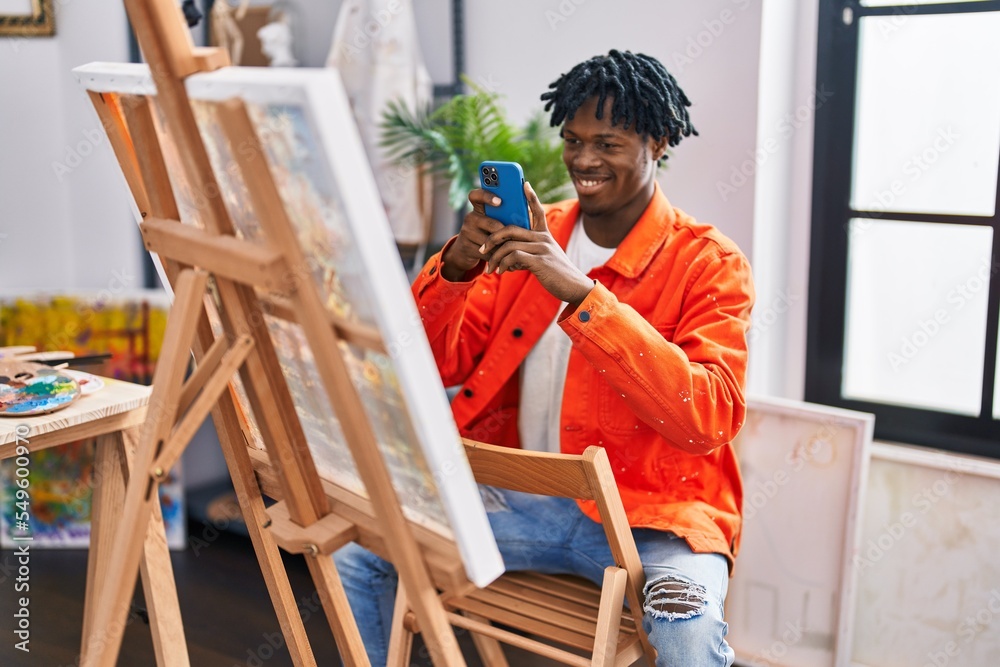 African american man artist smiling confident make picture by smartphone to draw at art studio