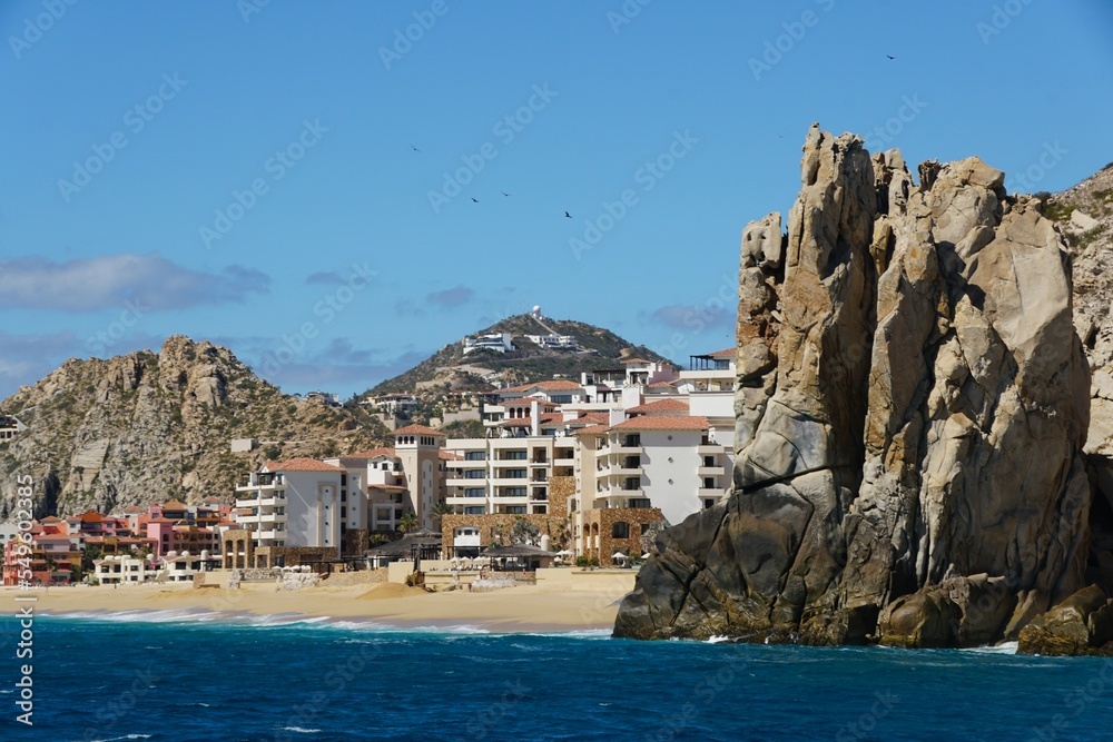 The rock formation and luxury waterfront resort hotels by the beach near Cabo San Lucas, Mexico 