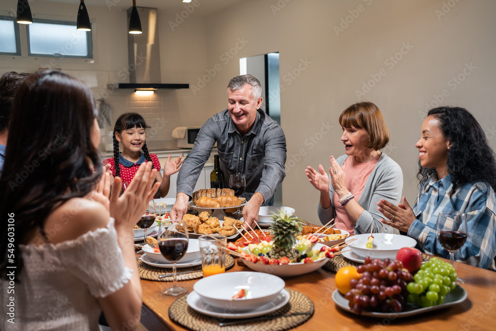 Multi-ethnic big family having dinner, enjoy evening party in house. Multi-ethnic big family having dinner, enjoy evening party in house.