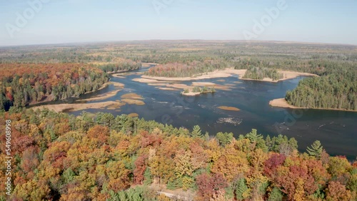 Au Sable River in Michigan with fall colors and drone video moving over trees. photo