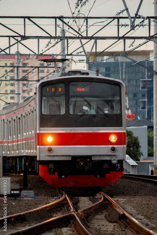 Jakarta- November 18, 2022: The commuter line at manggarai station passes in the afternoon. the commuter line itself is still one of the mainstay transportation for the people of Jakarta and people in Jakarta- November 18, 2022: The commuter line at manggarai station passes in the afternoon. the commuter line itself is still one of the mainstay transportation for the people of Jakarta and people in