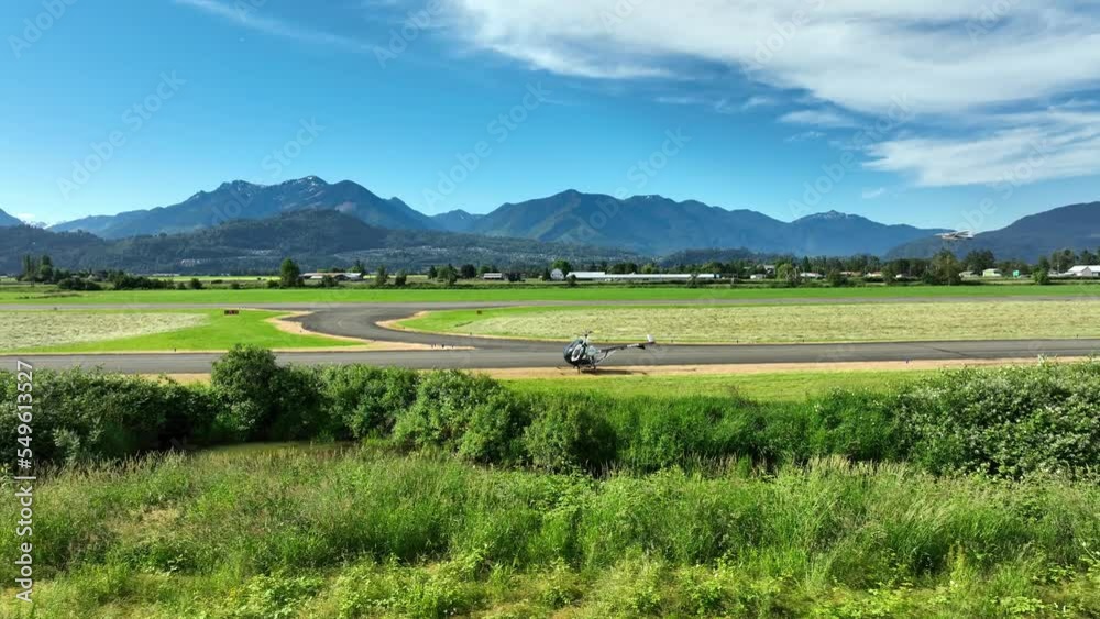A Helicopter Landing On The Runway In Chilliwack Municipal Airport, BC Canada. Aerial Shot A Helicopter Landing On The Runway In Chilliwack Municipal Airport, BC Canada. Aerial Shot