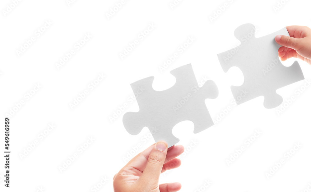 Jigsaw puzzles in the hands of child and adult on a white background. Different ages but support each other. Relationships within the family. Respect adults and be kind to children concept. Jigsaw puzzles in the hands of child and adult on a white background. Different ages but support each other. Relationships within the family. Respect adults and be kind to children concept.
