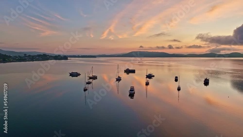 Soft and dreamy sunrise over Brisbane Water with clouds, fog and boats at Koolewong and Tascott on the Central Coast, NSW, Australia.