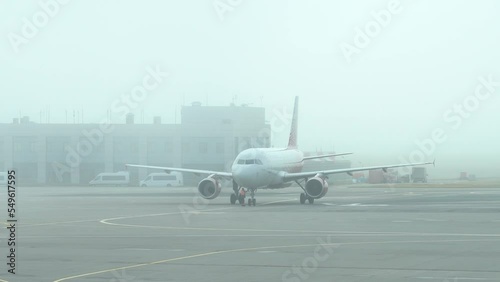 Vnukovo Airport, plane taxiing at airfield during heavy fog photo