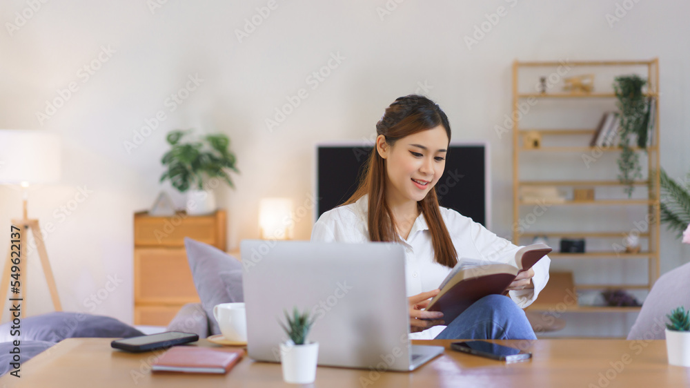 Working lifestyle at home concept, Women reading holy bible after working at modern home office Working lifestyle at home concept, Women reading holy bible after working at modern home office