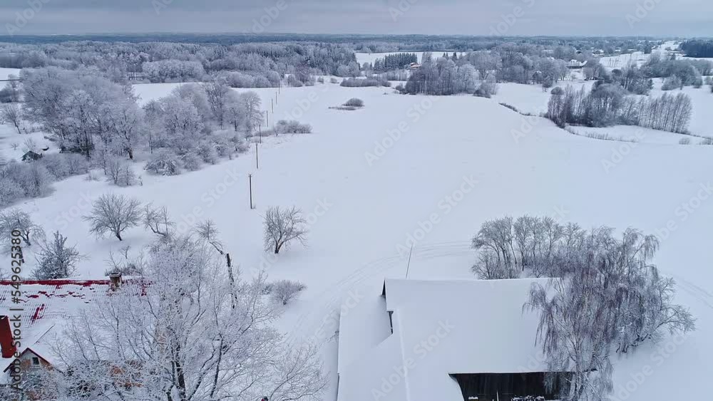 Village buildings covered in thick layer of snow, winter wonderland, aerial view Village buildings covered in thick layer of snow, winter wonderland, aerial view