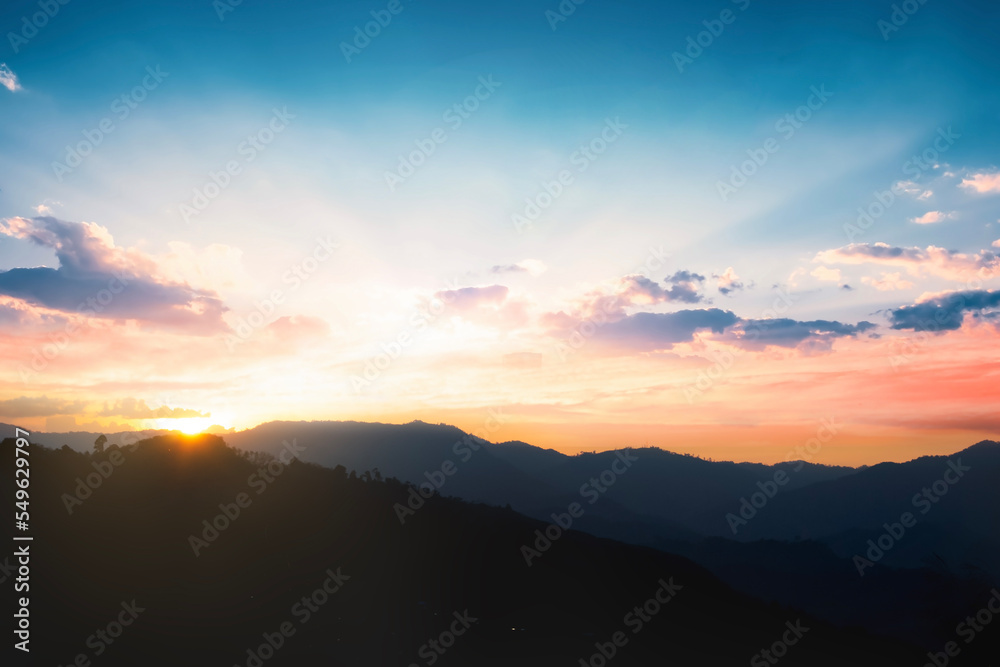 Panoramic mountains and dramatic sky sunrise background