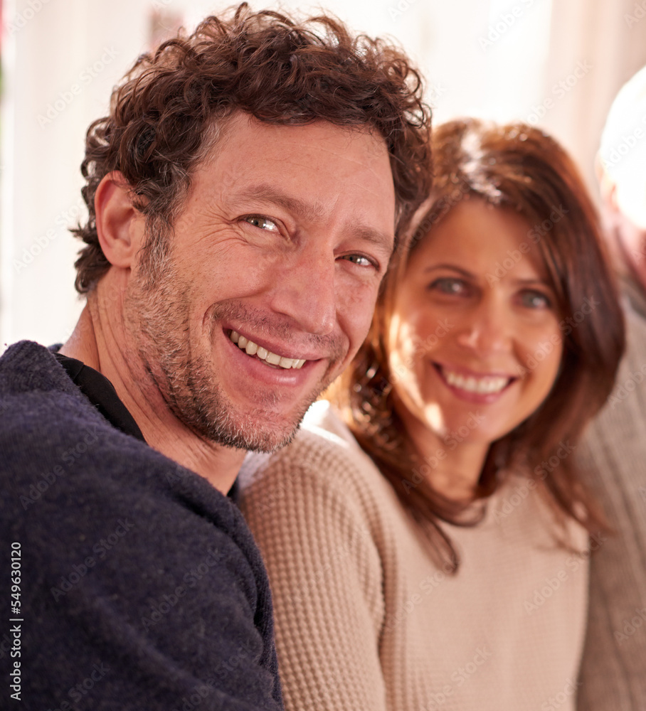 Portrait, couple and happy on a sofa together, bond, relax and smile in living room in their home. Love, family and face of man with woman on couch, enjoy relationship, quality time and joy in Italy