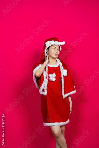 Young Asian Woman Posing While Wearing Her Christmas Themed Attire With Isolated Red Background