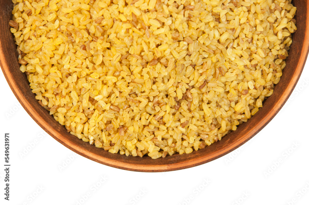 bulgur in a clay bowl on a white background. the concept of a good harvest of bulgur bulgur in a clay bowl on a white background. the concept of a good harvest of bulgur