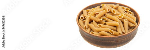pasta in a clay bowl on a white background. durum noodles on a light texture. italian penne in a brown bowl on a white surface