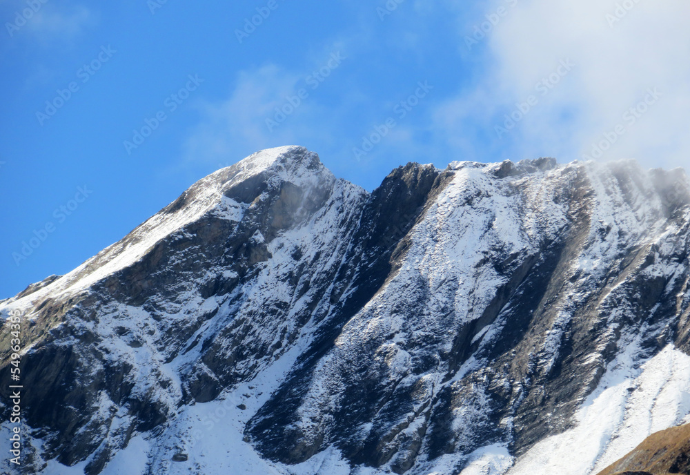 The first autumn snow on the Alpine peak Älplichopf (2641 m) in the Swiss Alps and in the UNESCO World Heritage Tectonic Arena Sardona (UNESCO-Welterbe Tektonikarena Sardona), Vättis - Switzerland