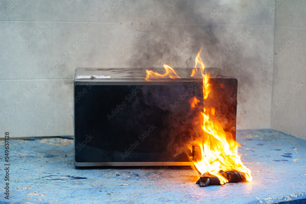 microwave oven on fire. the concept of fire in the kitchen and