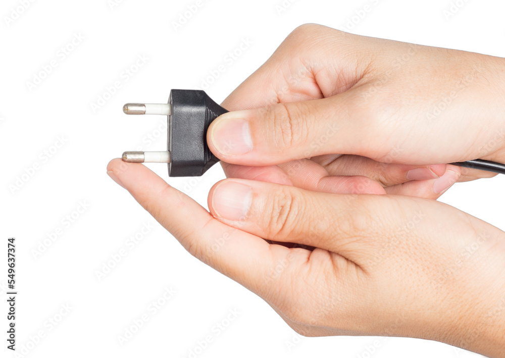 closeup hand holding electrical plug and power socket closeup hand holding electrical plug and power socket