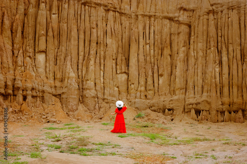 Fotografie Women and landscape of soil textures eroded sandstone pillars, columns and cliffs, natural erosion of water and wind, Sao Din Na Noi, Hom Chom, Khok Suea at sri nan national park in Nan Province