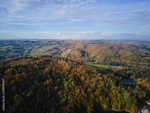 Drone flight over mountains covered with forest at autumn season. Beautiful nature landscape