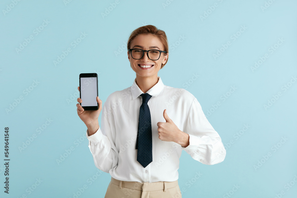 Happy Businesswoman Showing Smartphone. Caucasian Lady Smiling while Showing Cellphone, Recommended App, Enjoying Mobile Service. Empty Copy Space for Advertisement, Indoor Studio Shot Happy Businesswoman Showing Smartphone. Caucasian Lady Smiling while Showing Cellphone, Recommended App, Enjoying Mobile Service. Empty Copy Space for Advertisement, Indoor Studio Shot
