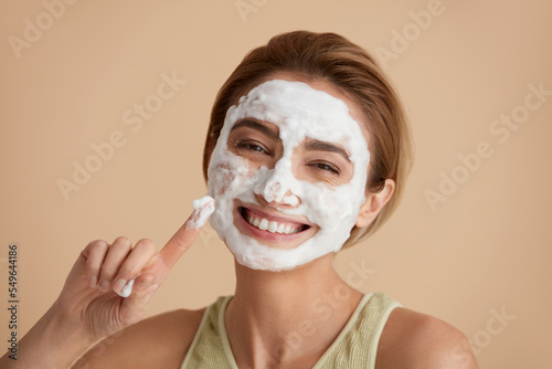 Face Skin Care. Happy Caucasian Woman Posing with Foam Soap on Face. Positive Girl Cleansing Face Applying Facial Cleanser Closeup. Cleaning Facial Skin Concept. High Resolution 