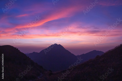 Dramatic sunset over the mountains at Sunset Peak, looking to Lantau Peak, Lantau Island, Hong Kong
