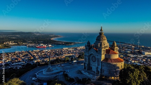 Scenic view of the Viana do Castelo with overlooking city buildings and the blue ocean during sunset photo