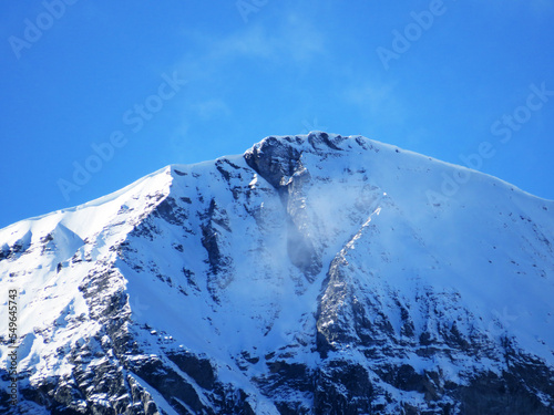 The first autumn snow on the Alpine peak Piz Sardona (3056 m) in the Swiss Alps and in the UNESCO World Heritage Tectonic Arena Sardona (UNESCO-Welterbe Tektonikarena Sardona), Vättis - Switzerland photo