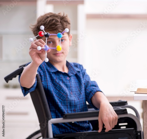 Disabled kid preparing for school at home photo